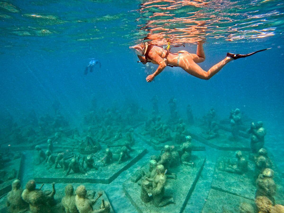 Woman snorkeling over the Under SXM reef sculptures